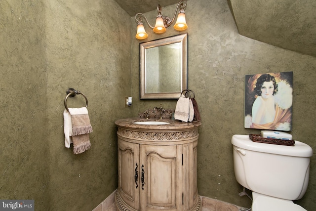 bathroom with toilet and vanity