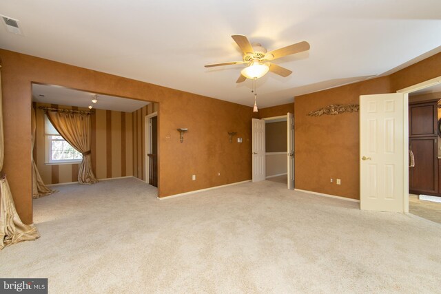 carpeted spare room with ceiling fan