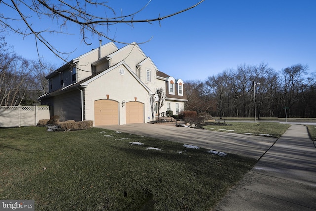 view of home's exterior featuring a garage and a yard