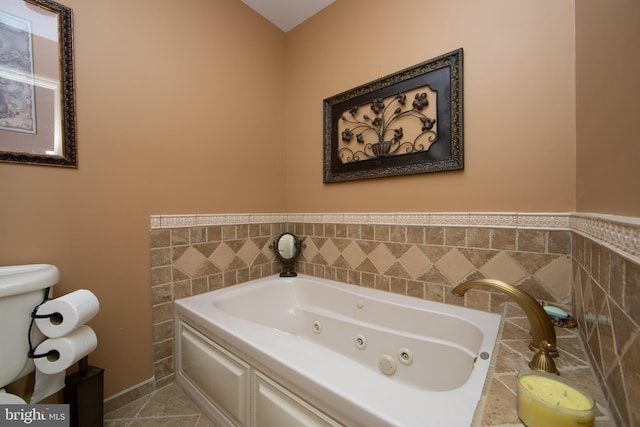 bathroom featuring tile walls, tile patterned floors, and a washtub