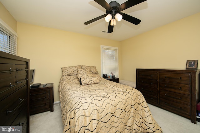 bedroom featuring light carpet and ceiling fan