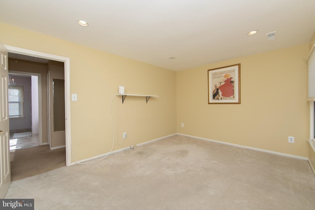 spare room featuring light colored carpet