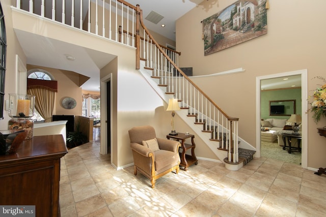 stairs featuring a high ceiling