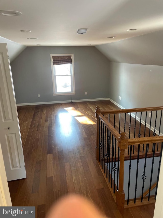 additional living space with lofted ceiling and dark hardwood / wood-style floors