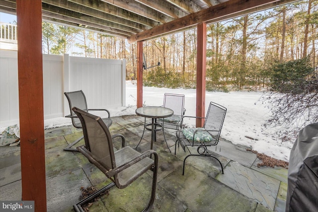 snow covered patio featuring grilling area