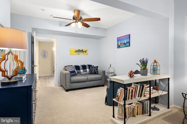 carpeted living room featuring ceiling fan