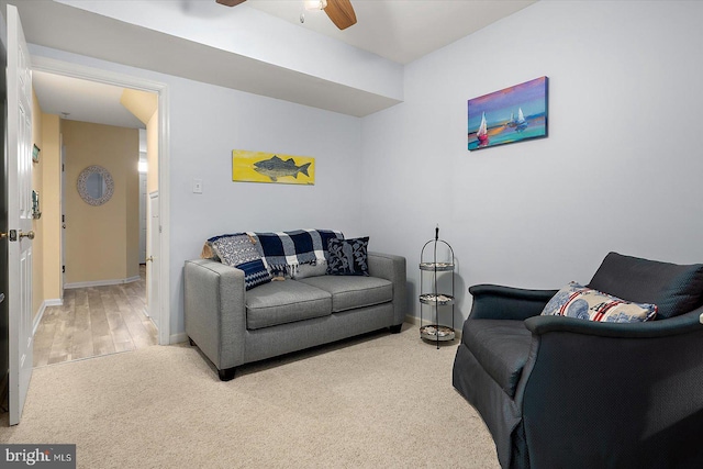 carpeted living room with ceiling fan