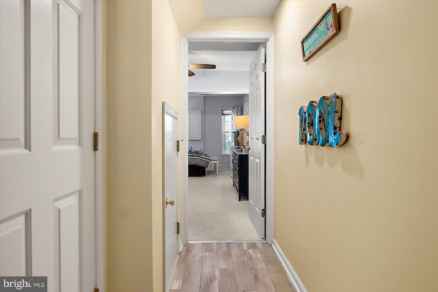 hallway with light hardwood / wood-style floors