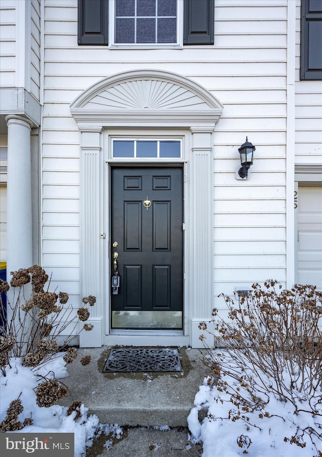 view of snow covered property entrance