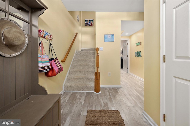 staircase with hardwood / wood-style flooring