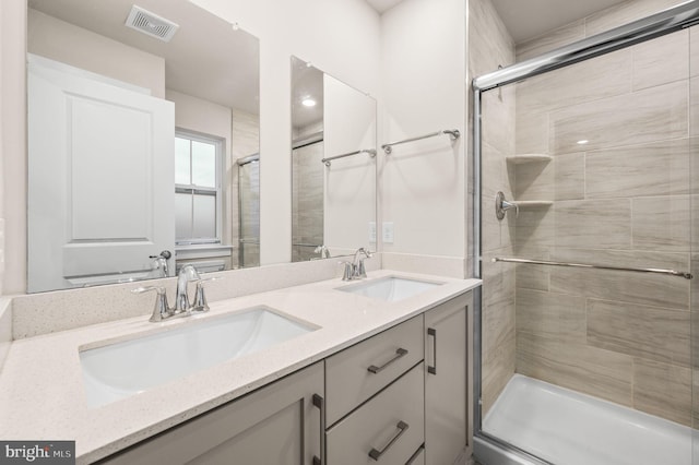 bathroom featuring vanity and a shower with door