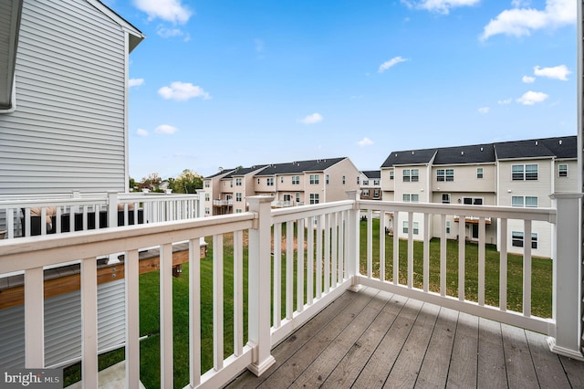 wooden terrace featuring a yard