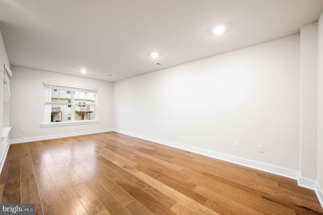 empty room with hardwood / wood-style floors