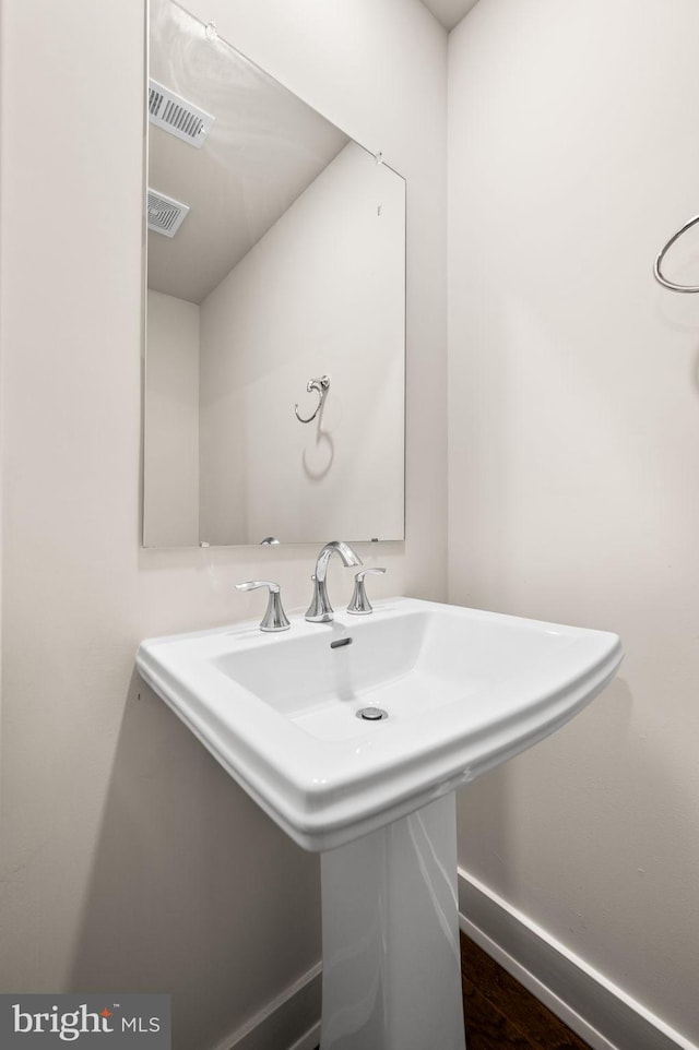 bathroom with sink and hardwood / wood-style floors