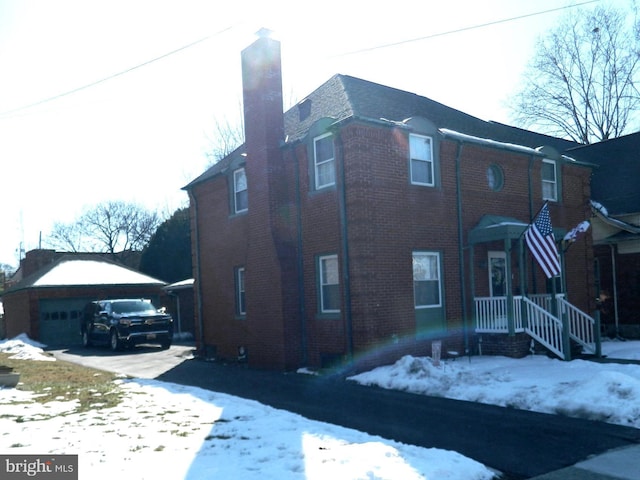 view of snow covered exterior with a garage