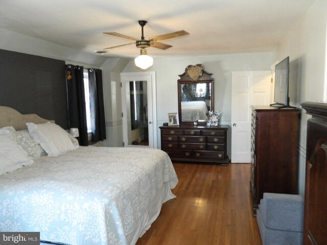 bedroom with dark hardwood / wood-style floors and ceiling fan