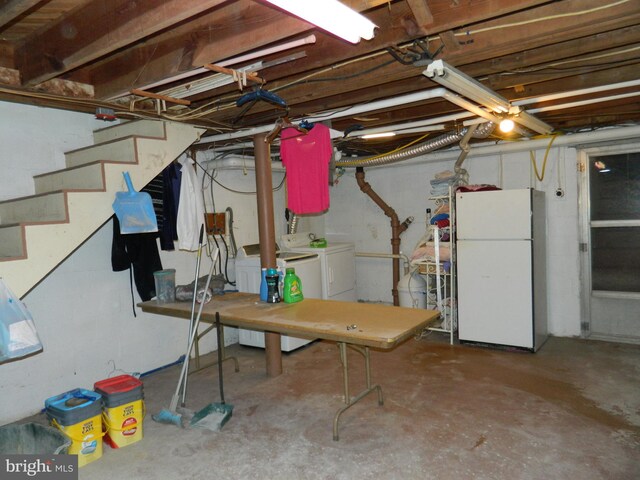 basement with white refrigerator and independent washer and dryer