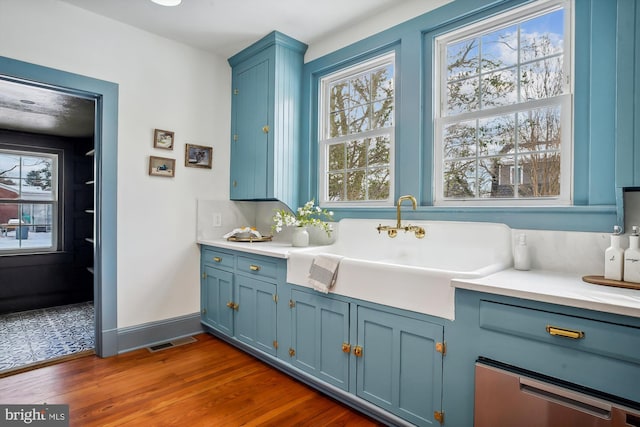 interior space with hardwood / wood-style floors, decorative backsplash, and sink