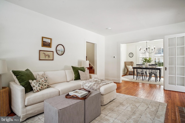 living room featuring light hardwood / wood-style floors and a chandelier