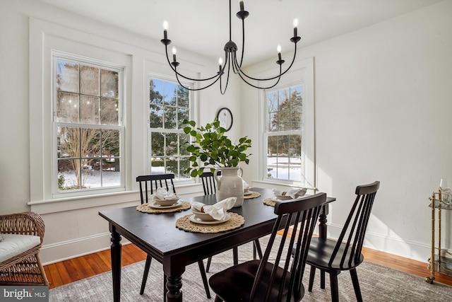 dining area with an inviting chandelier and wood-type flooring