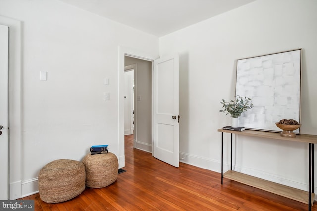 living area with hardwood / wood-style floors