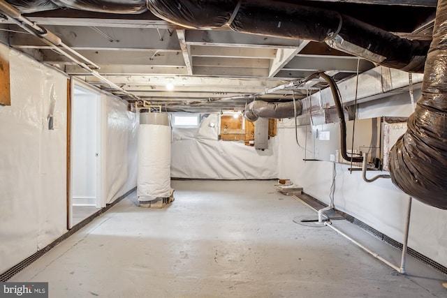 basement with electric panel and water heater