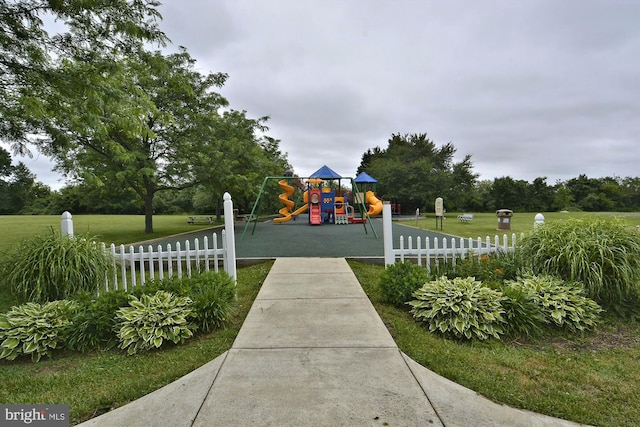 surrounding community featuring a playground and a lawn