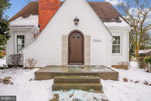 view of snow covered property entrance