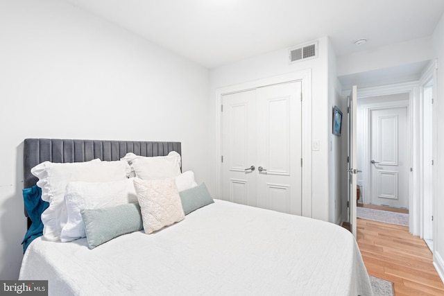 bedroom featuring hardwood / wood-style floors and a closet