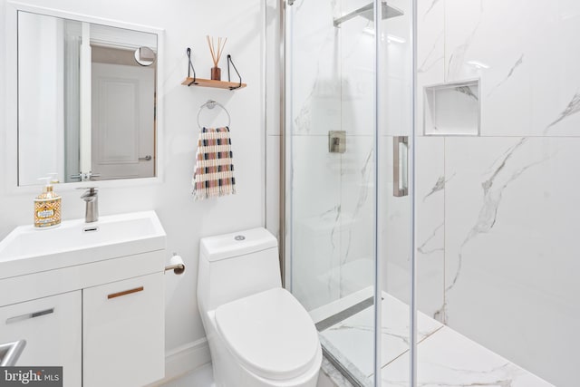 bathroom featuring toilet, an enclosed shower, and vanity