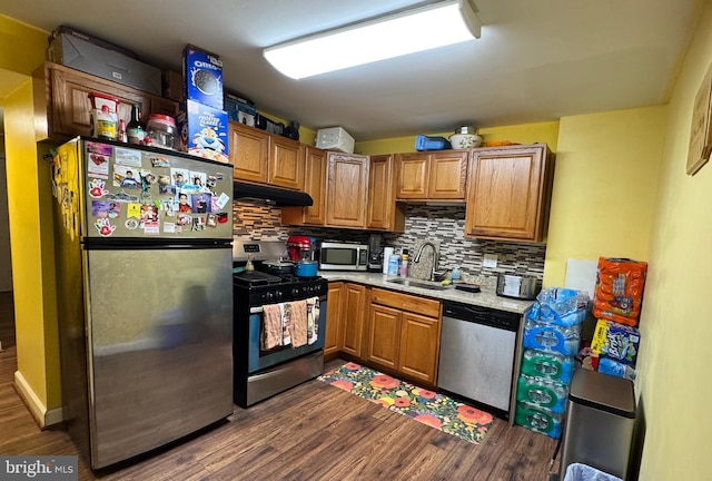 kitchen featuring tasteful backsplash, sink, dark hardwood / wood-style flooring, and appliances with stainless steel finishes