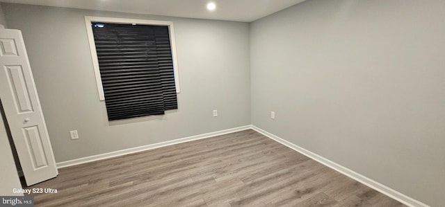 empty room with hardwood / wood-style flooring