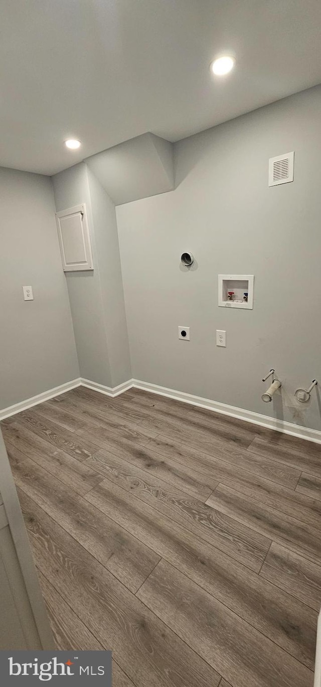 laundry area featuring washer hookup, wood-type flooring, electric dryer hookup, and hookup for a gas dryer