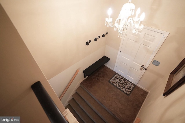 tiled entrance foyer featuring a chandelier