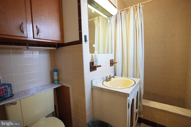 bathroom with toilet, walk in shower, decorative backsplash, tile walls, and vanity