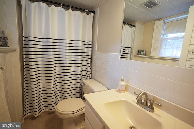 bathroom featuring tile walls, a shower with curtain, toilet, tile patterned floors, and vanity