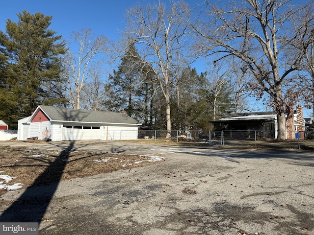 view of yard with a garage and an outbuilding