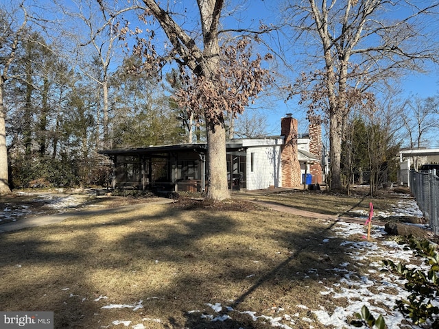 view of snowy exterior featuring a yard