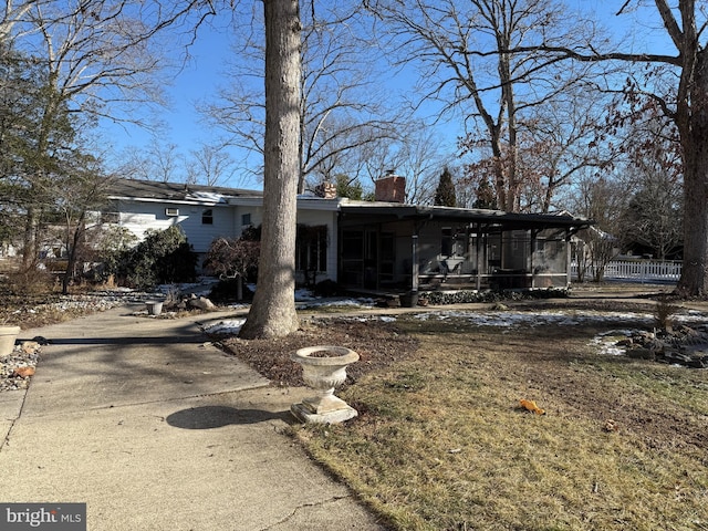 view of front of house featuring a sunroom