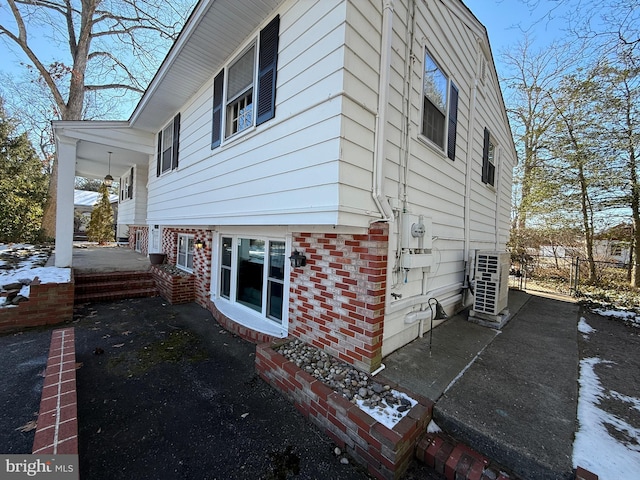 view of snowy exterior featuring a patio area