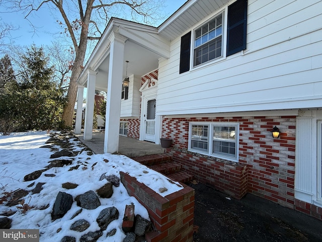 view of snow covered property entrance