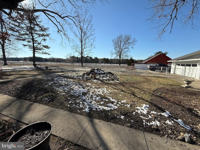 view of yard with a rural view