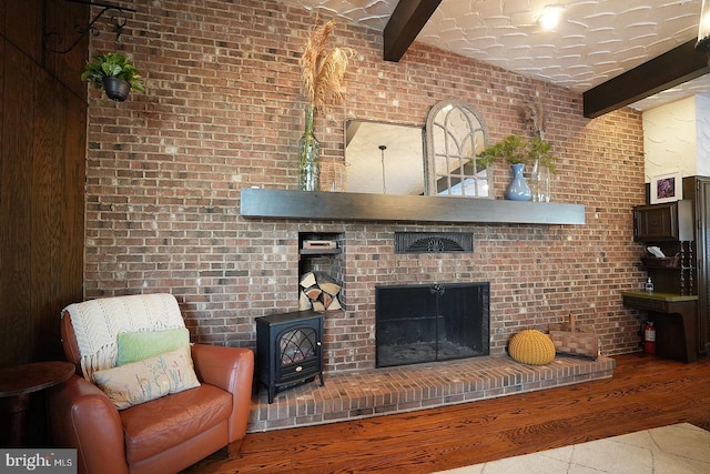 living room featuring brick wall and beam ceiling