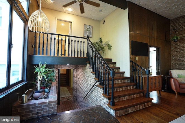 stairway featuring hardwood / wood-style floors and ceiling fan