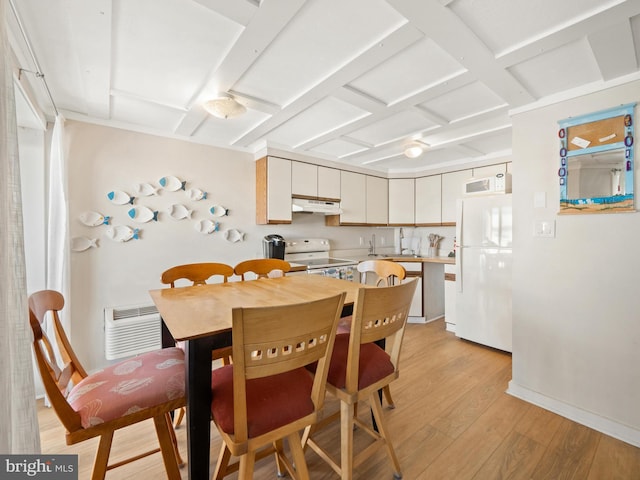 kitchen with white appliances and light hardwood / wood-style flooring