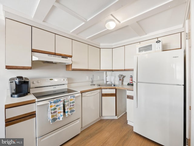 kitchen featuring white appliances, white cabinets, light wood-type flooring, and sink