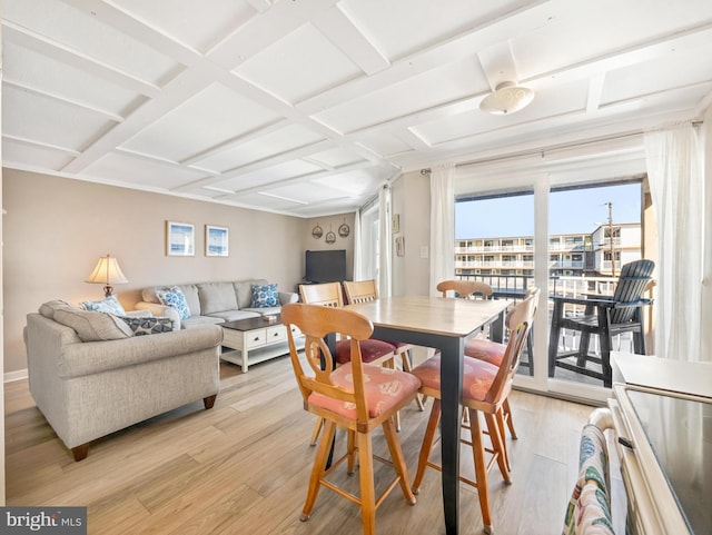 dining space with light hardwood / wood-style flooring and coffered ceiling