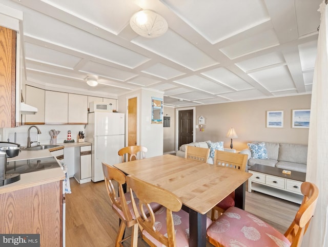 dining area featuring sink and light hardwood / wood-style floors