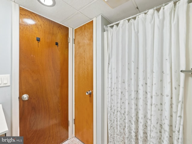 bathroom with a paneled ceiling