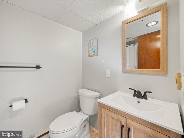 bathroom featuring a baseboard heating unit, vanity, and toilet